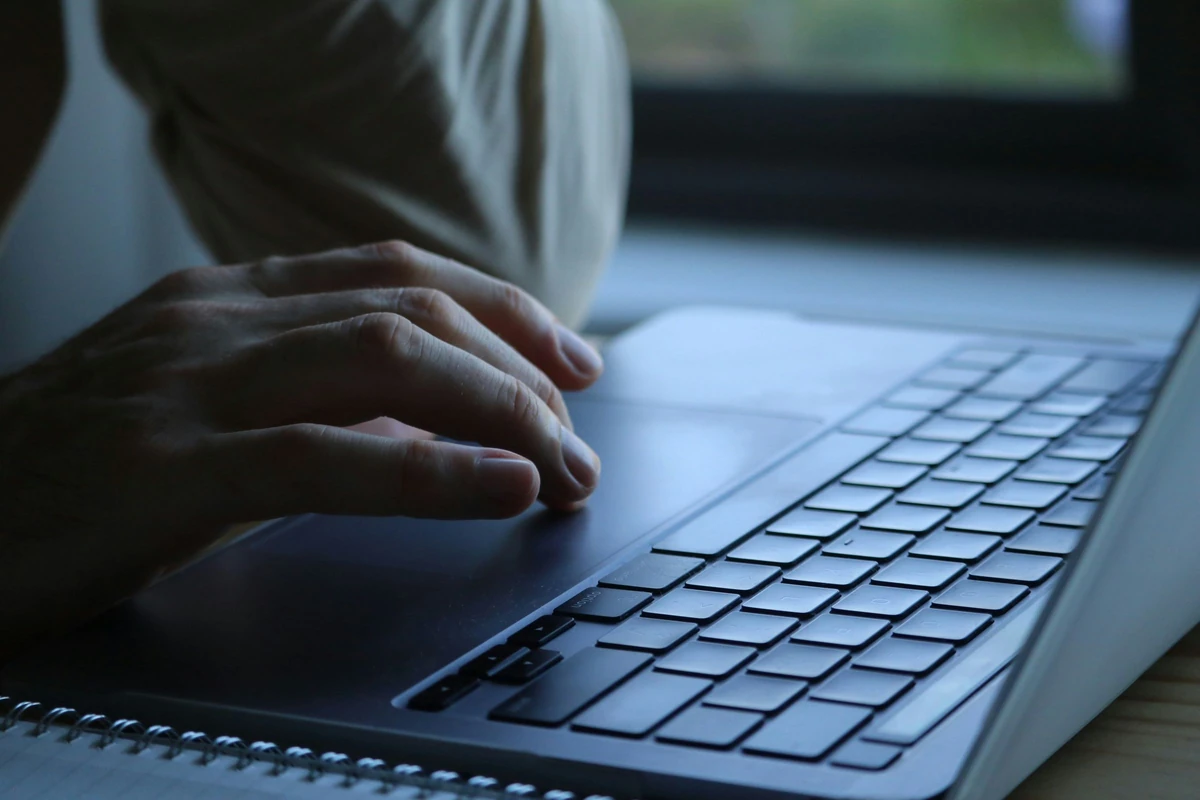 Close-up of hands using a laptop keyboard in an illustrative stock photograph