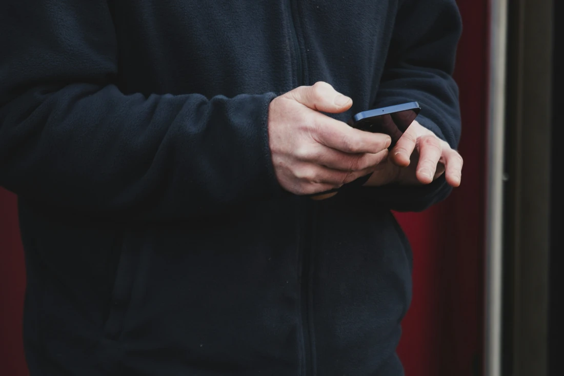 Hands using a smartphone, illustrating a mobile visitor's enquiry journey