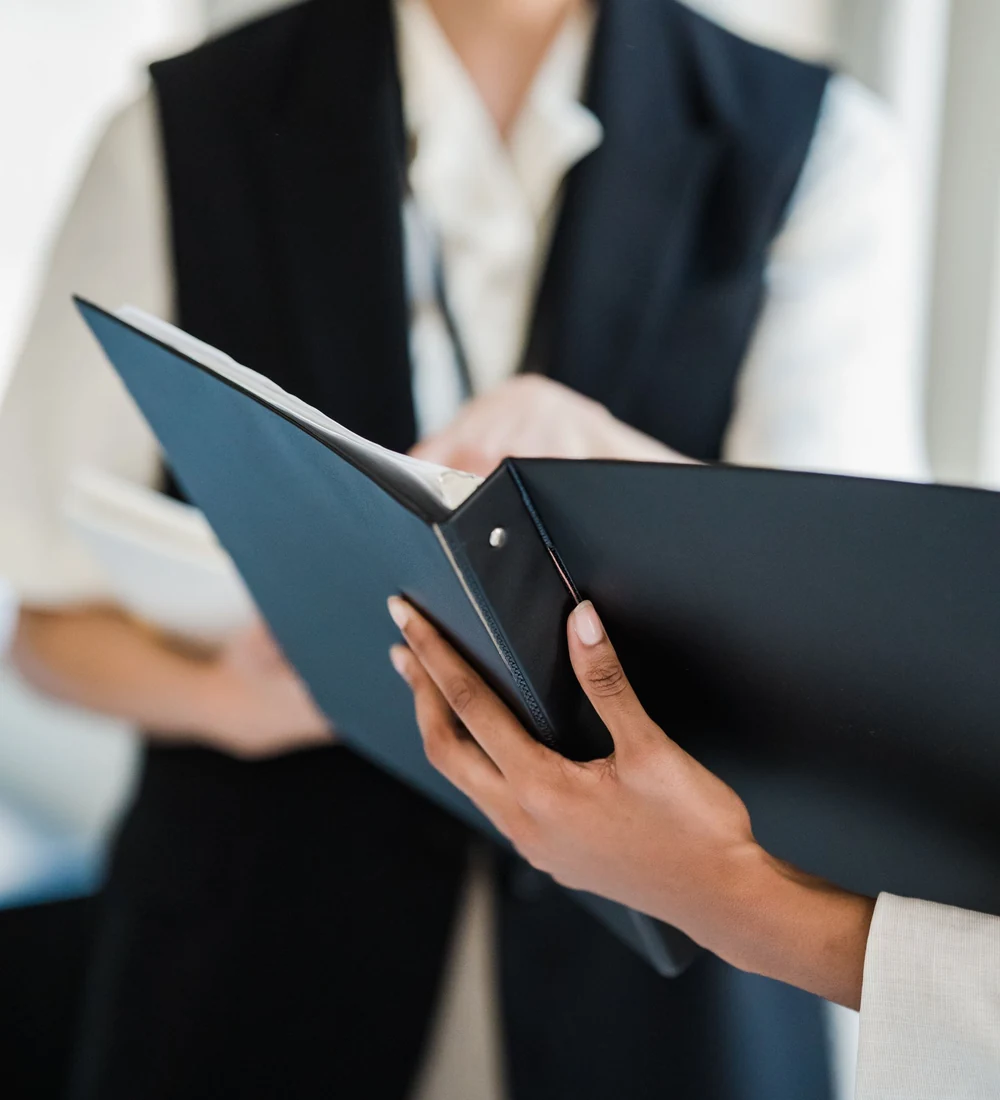 Professionals reviewing a document folder, illustrating the need to define authorised reviewers